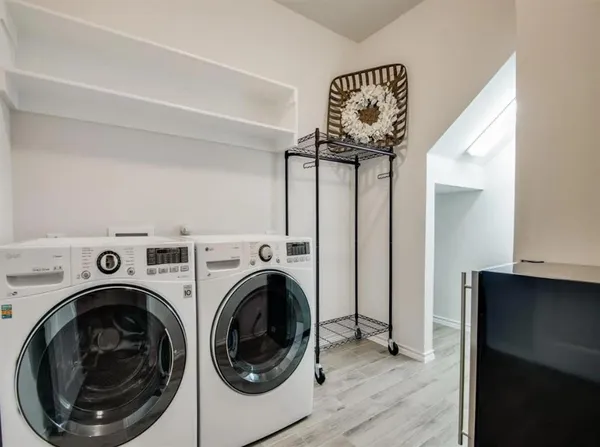 a view of a hallway with washer and dryer