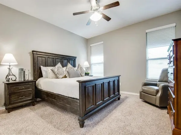 a bedroom with bed and a chandelier