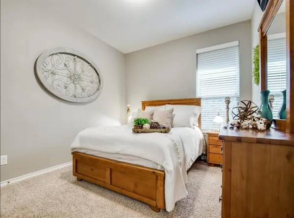 a bedroom with a bed and a potted plant