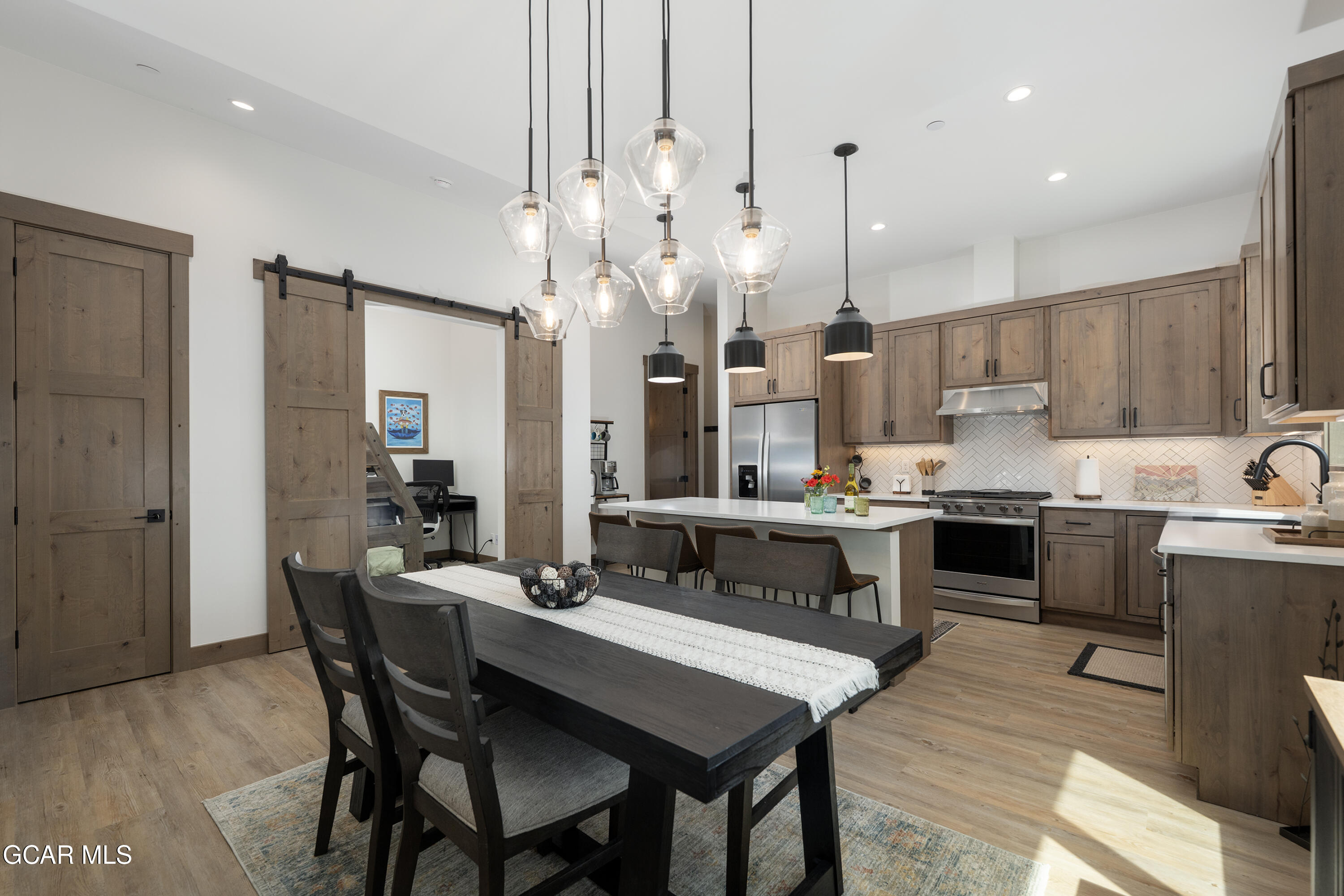 96 Meadow Trail, Unit G304 Fraser, CO 80442 - Photo 9 of 37 a kitchen with kitchen island granite countertop a sink counter top space stainless steel appliances and cabinets