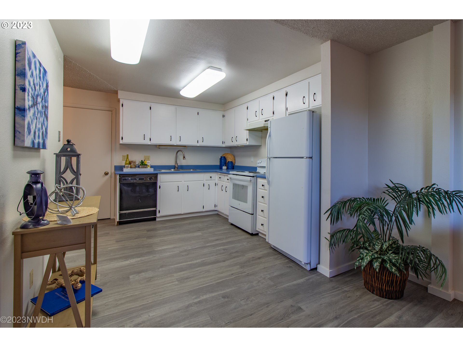 1302 Quaker Street Eugene, OR 97402 - Photo 13 of 28 a kitchen with a refrigerator and a stove top oven