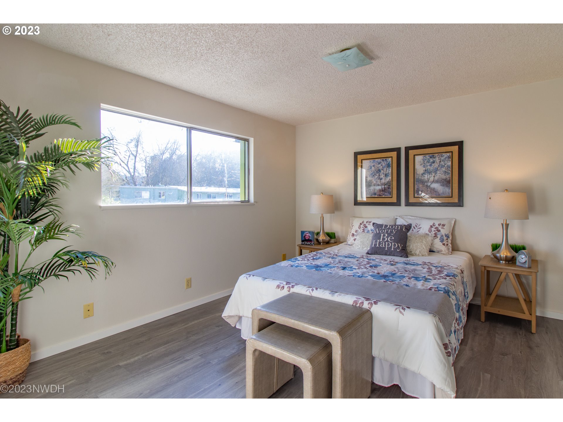 1302 Quaker Street Eugene, OR 97402 - Photo 16 of 28 a bedroom with a bed and a potted plant on table