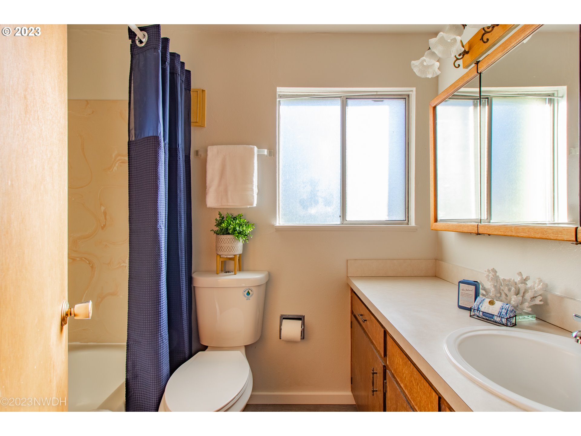 1302 Quaker Street Eugene, OR 97402 - Photo 18 of 28 a bathroom with a granite countertop toilet sink and mirror