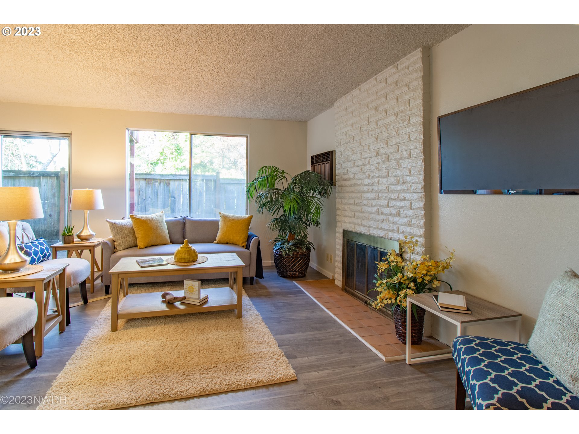 1302 Quaker Street Eugene, OR 97402 - Photo 5 of 28 a living room with patio furniture and a fireplace