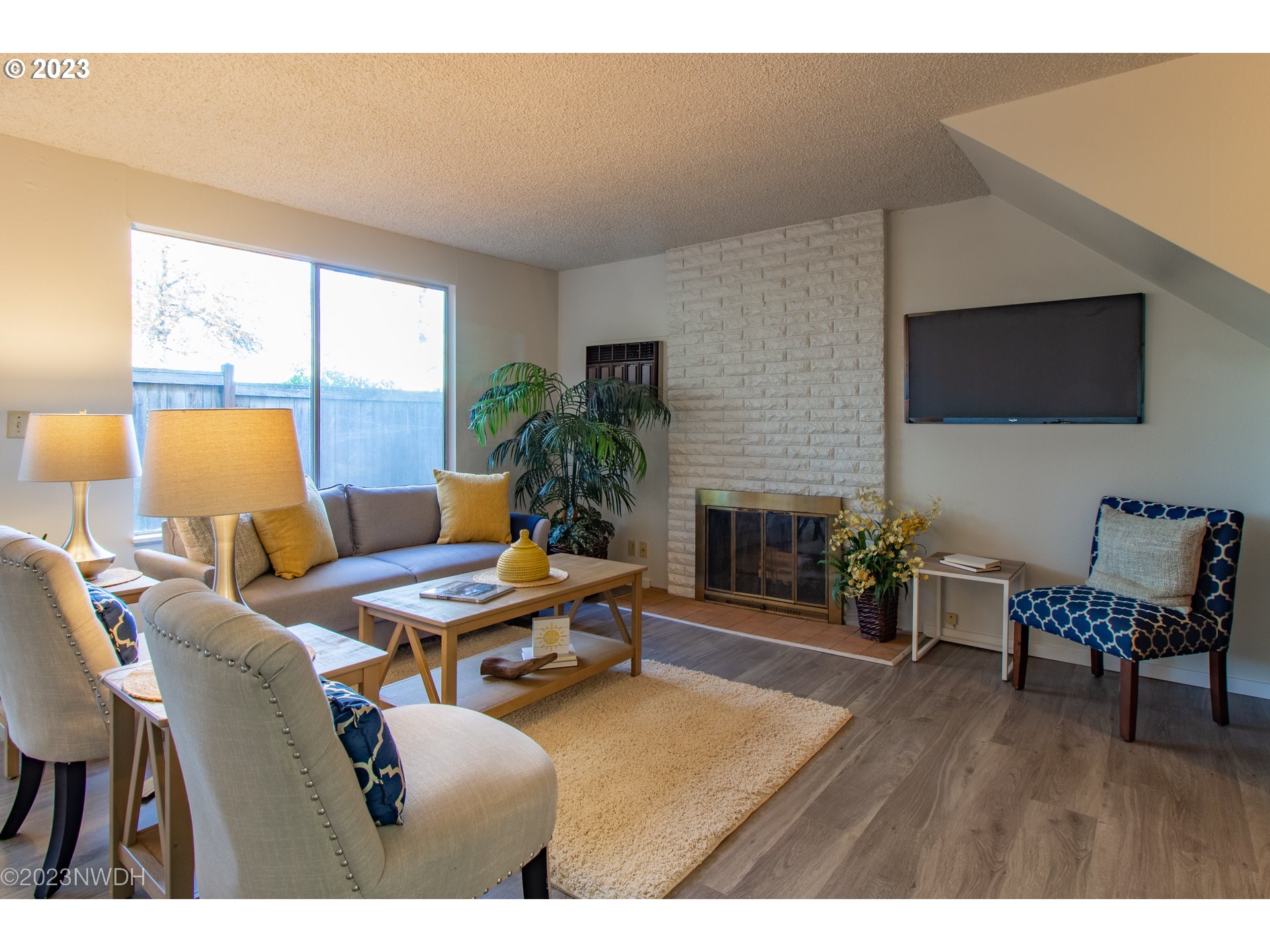 1302 Quaker Street Eugene, OR 97402 - Photo 6 of 28 a living room with furniture a large window and a fireplace