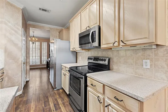 a kitchen with stainless steel appliances a stove a sink and a microwave