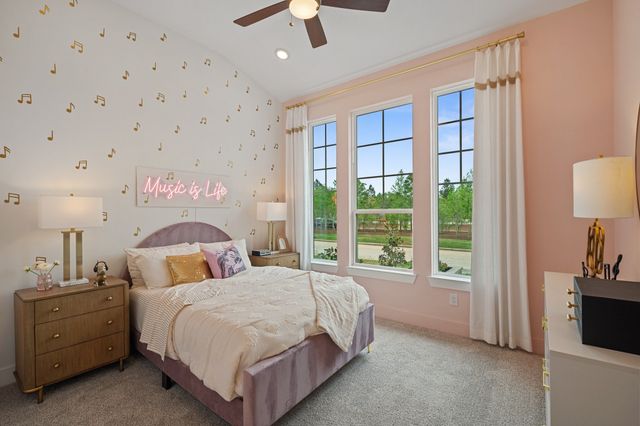 a spacious bedroom with a bed and a lamp