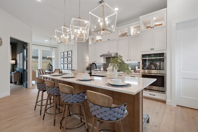 a kitchen with stainless steel appliances kitchen island granite countertop a table and chairs in it