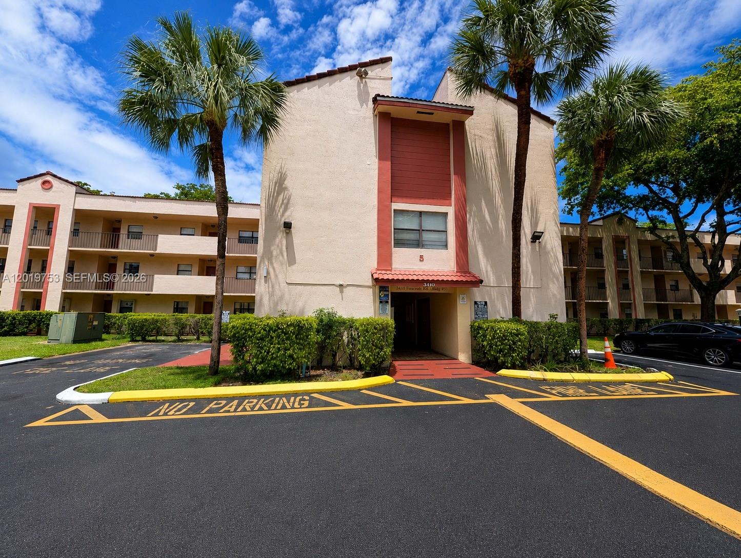 3410 Foxcroft Road, Unit 206 Miramar, FL 33025 - Photo 23 of 23 a front view of a house with a yard and garage