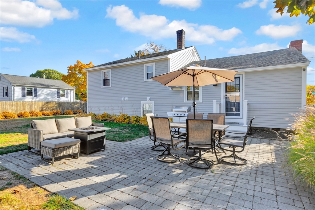 2 Morningside Drive Danvers, MA 01923 - Photo 20 of 25 a view of a patio with table and chairs under an umbrella