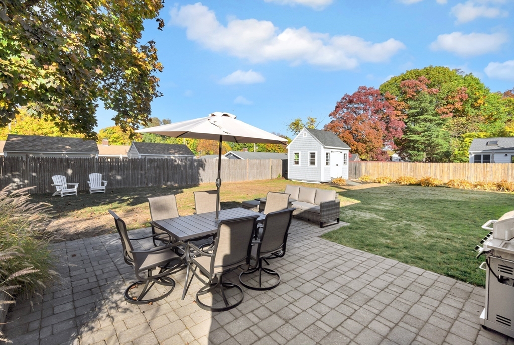 2 Morningside Drive Danvers, MA 01923 - Photo 21 of 25 a view of a patio with table and chairs under an umbrella