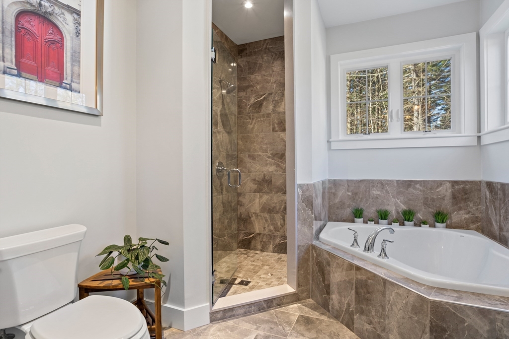 135 South Road Holden, MA 01520 - Photo 19 of 42 a bath tub sitting next to a white toilet and a shower