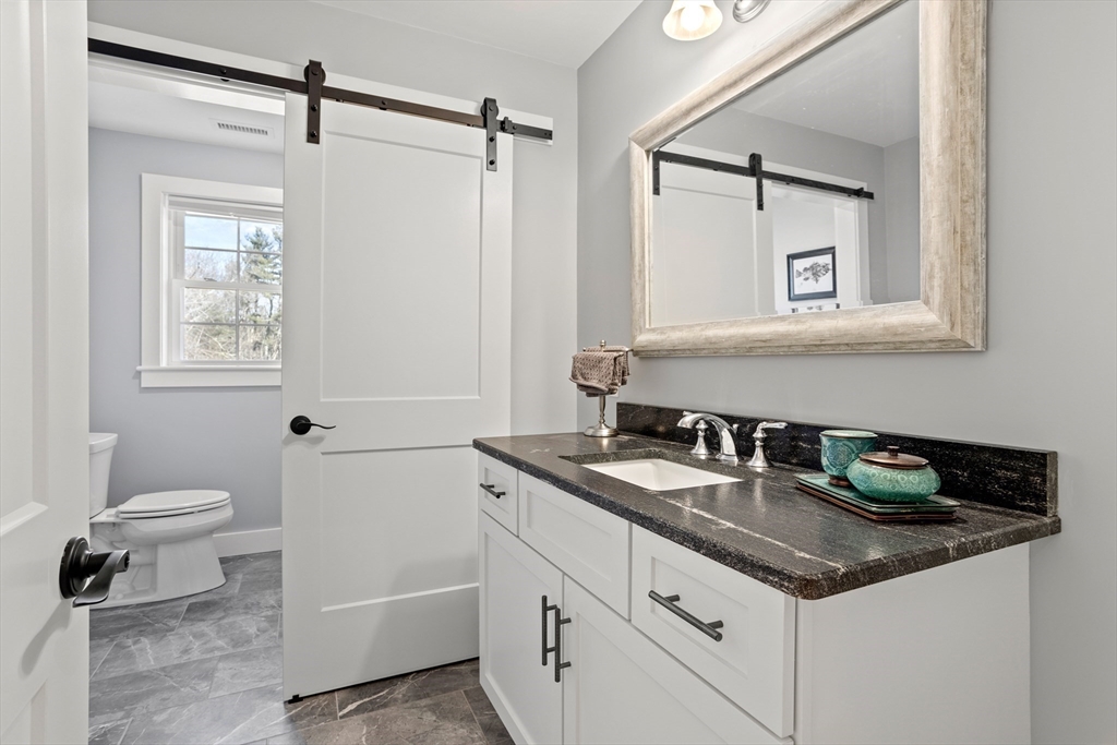 135 South Road Holden, MA 01520 - Photo 23 of 42 a bathroom with a granite countertop sink toilet and mirror