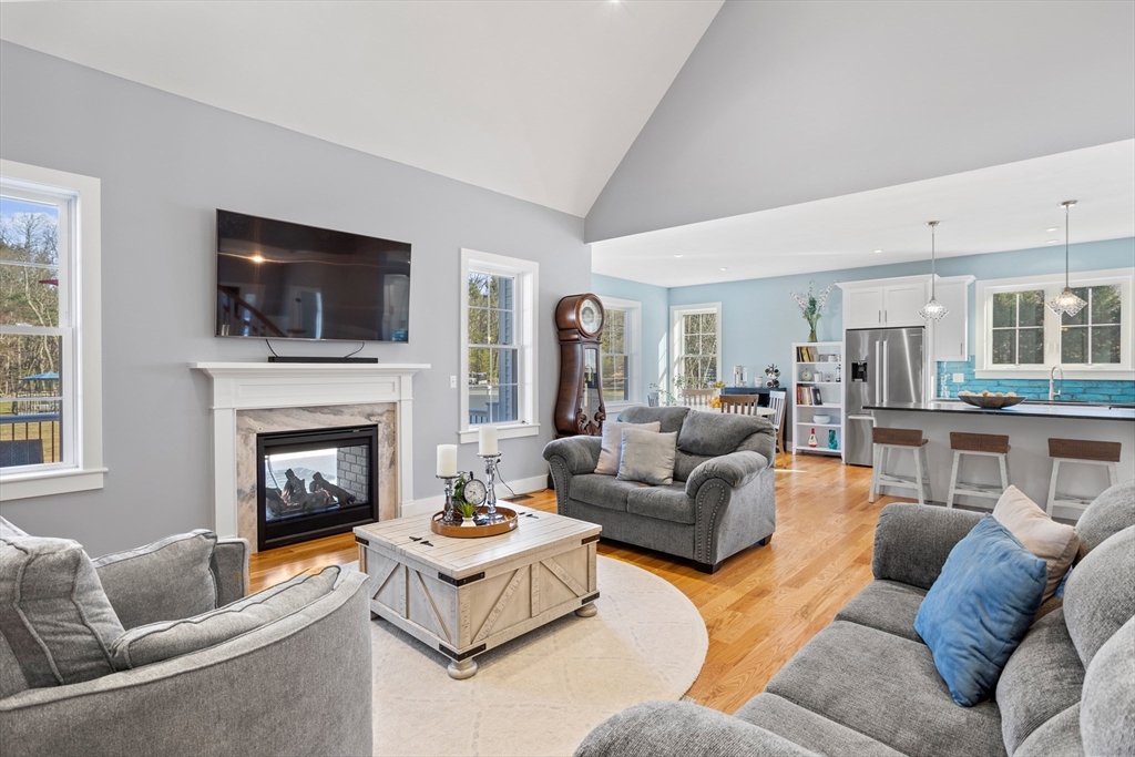 135 South Road Holden, MA 01520 - Photo 5 of 42 a living room with furniture a flat screen tv and a fireplace