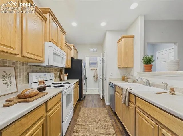 a kitchen with stainless steel appliances granite countertop a sink and cabinets
