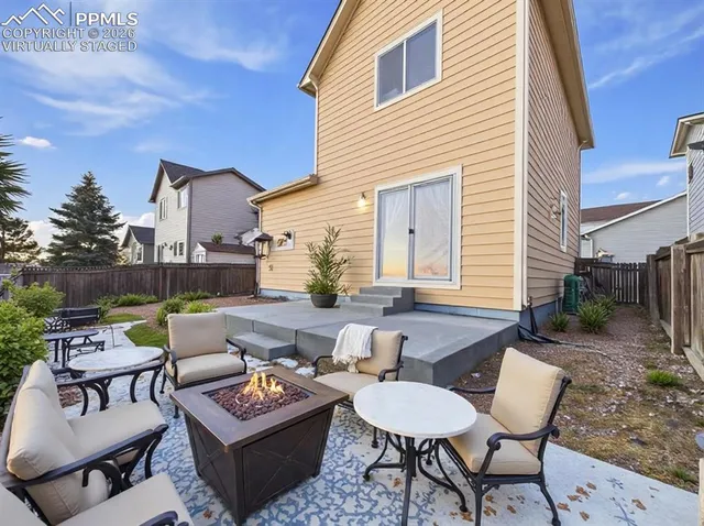 a view of a patio with couches and a potted plant on the table
