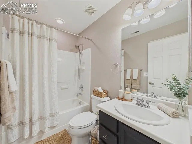 a bathroom with a sink vanity mirror and toilet