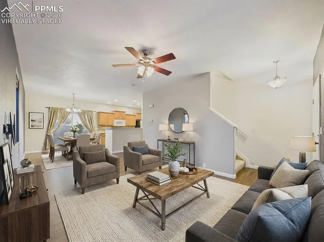 a living room with furniture a rug and a chandelier