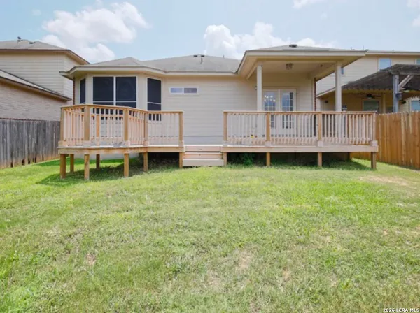 a backyard of a house with wooden fence