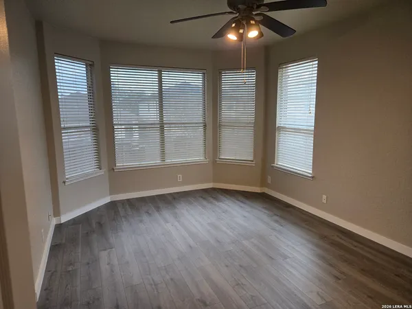 a view of an empty room with wooden floor