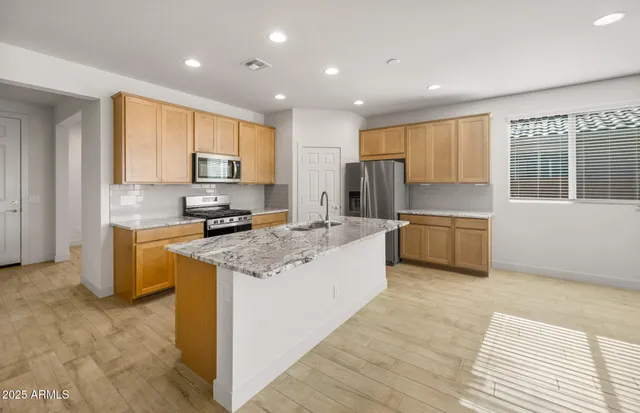 a stove top oven sitting inside of a kitchen