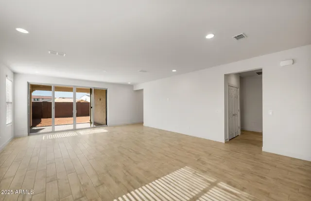a kitchen with a refrigerator a stove top oven a sink and cabinets