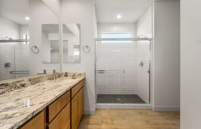 a bathroom with a granite countertop sink mirror and double