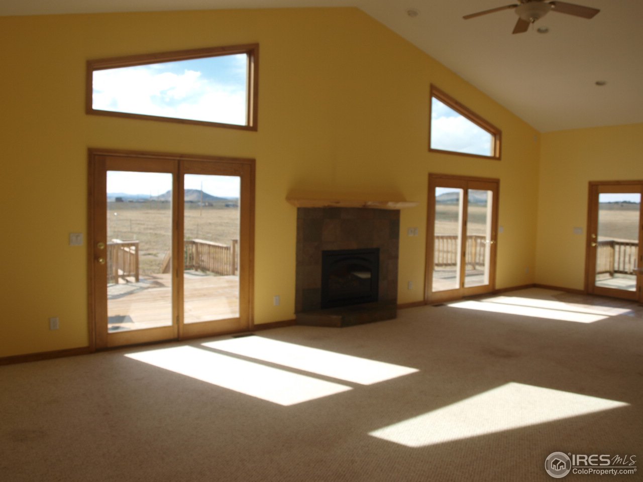8867 Old Ranch Road Livermore, CO 80536 - Photo 5 of 25 Great room with fireplace and vaulted ceilings