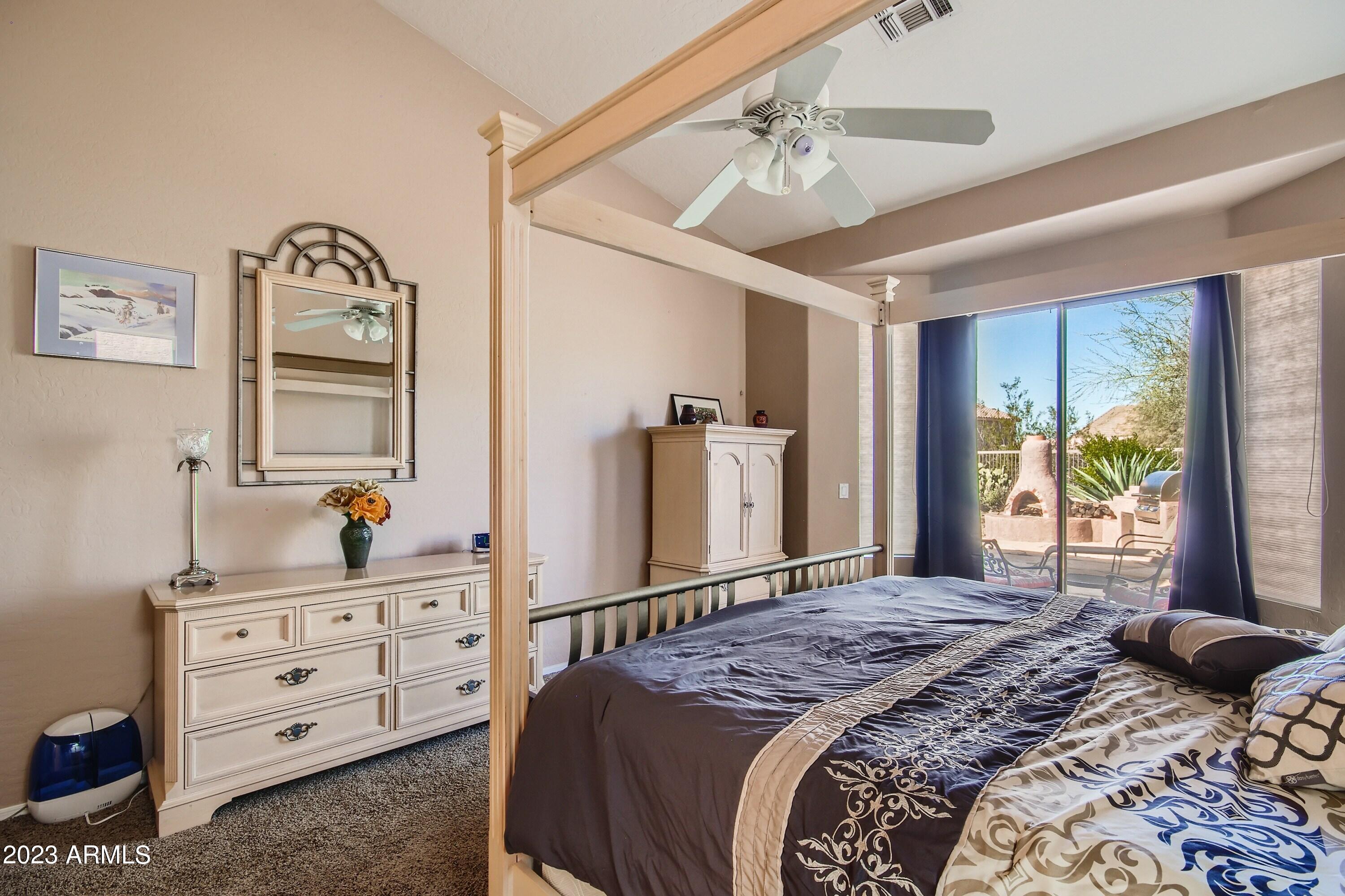 3060 North Ridgecrest, Unit 175 Mesa, AZ 85207 - Photo 18 of 28 a bedroom with a bed and a dresser in it