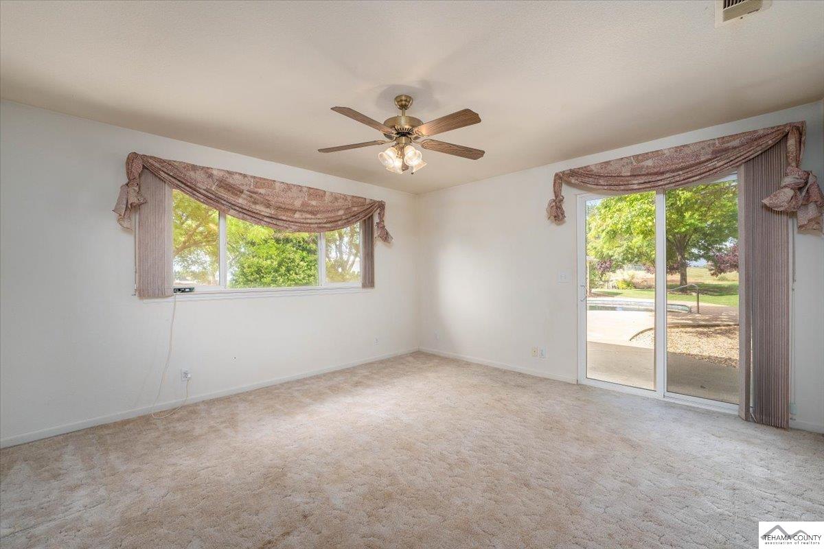 19950 Red Bank Road Red Bluff, CA 96080 - Photo 27 of 69 an empty room with windows and chandelier fan
