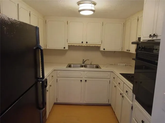 a utility room with cabinets washer and dryer