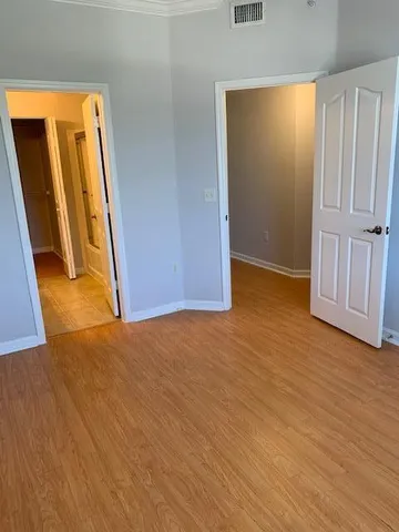 an empty room with wooden floor and a fireplace