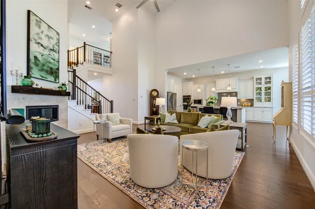 a living room with fireplace furniture and a wooden floor