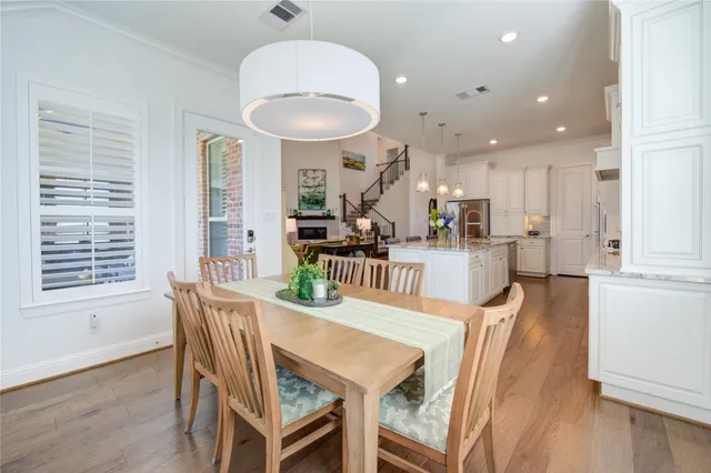 a dining room with furniture and wooden floor