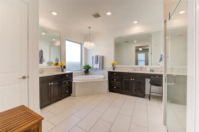 a large bathroom with a sink a mirror and a bathtub