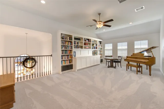 a view of a livingroom with furniture and floor to ceiling window