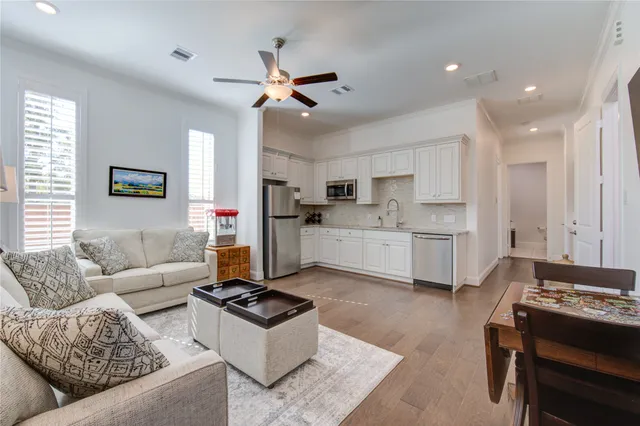 a living room with furniture and kitchen view