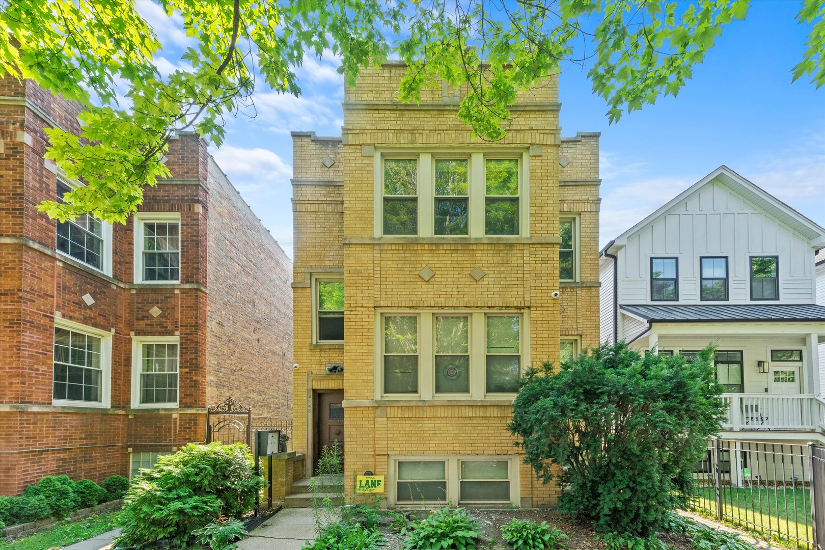 front view of a brick house with a yard