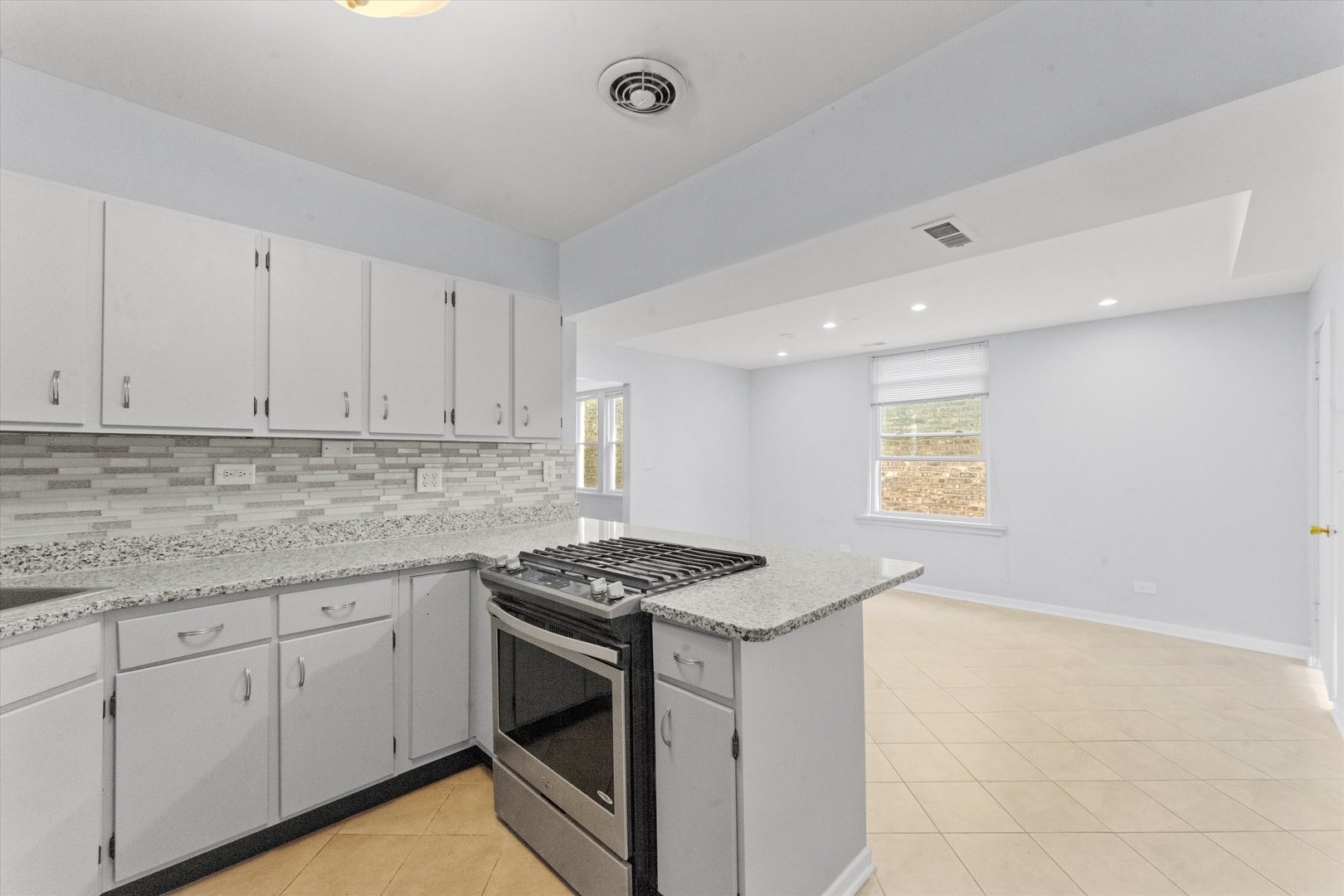 4846 North Keystone Avenue, Unit 2 Chicago, IL 60630 - Photo 6 of 12 a kitchen with granite countertop white cabinets stainless steel appliances and a counter space