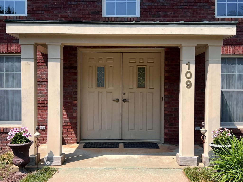 109 Buckingham Road Easley, SC 29640 - Photo 5 of 40 Welcome to this inviting entrance, showcasing a classic brick facade and a sheltered doorway.