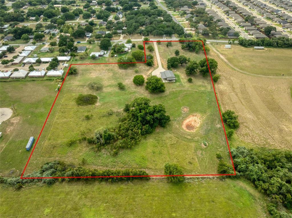 210 Spring Branch Trail North Springtown, TX 76082 - Photo 31 of 36 Expansive property featuring a single-story residence, a long private driveway, scattered mature trees, and open land bordered by natural vegetation