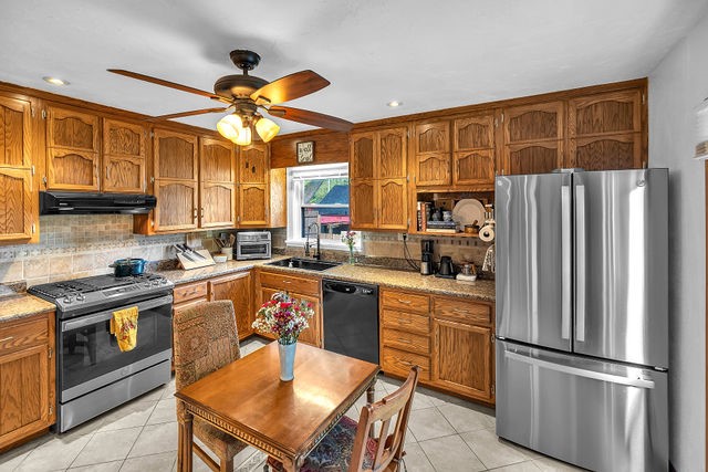 4170 North Taylor Avenue Decatur, IL 62526 - Photo 9 of 29 a kitchen with stainless steel appliances granite countertop a refrigerator a sink dishwasher a stove and white countertops with wooden floor