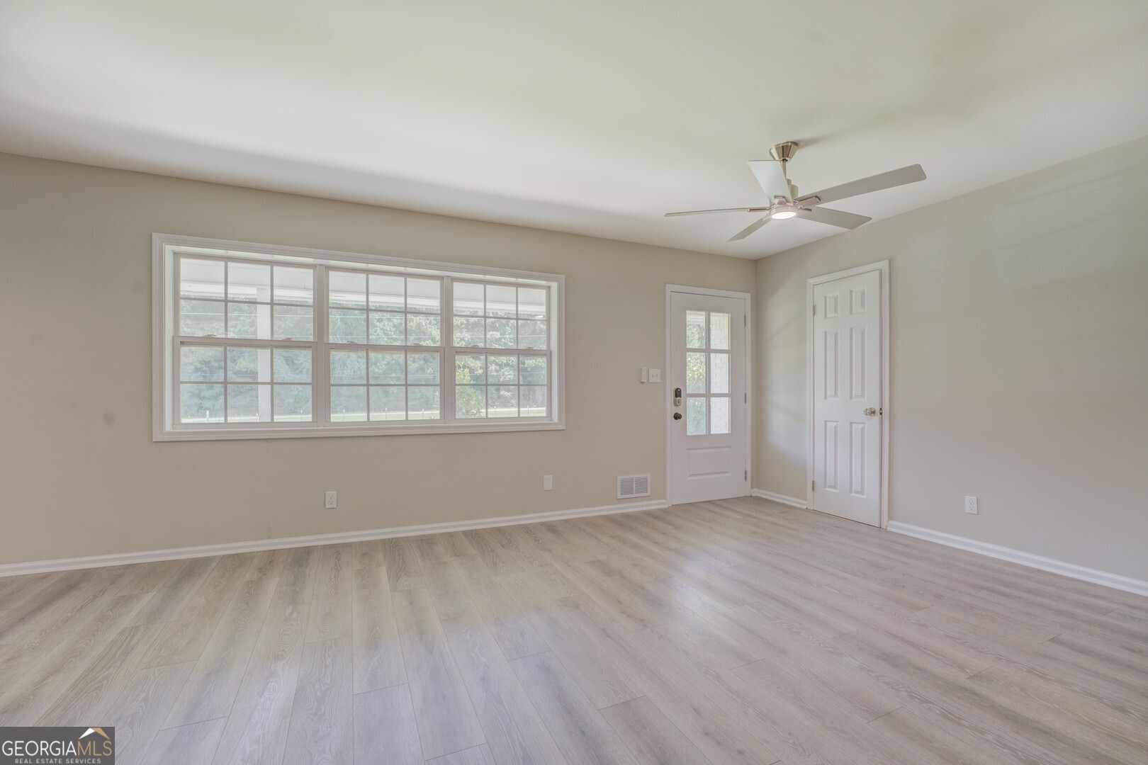 635 Jackson Lake Road Mansfield, GA 30055 - Photo 12 of 68 wooden floor in an empty room with a window