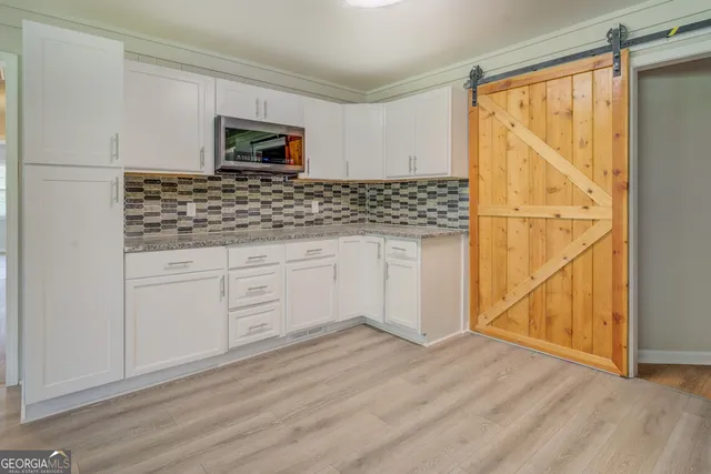 a stove top oven sitting inside of a kitchen