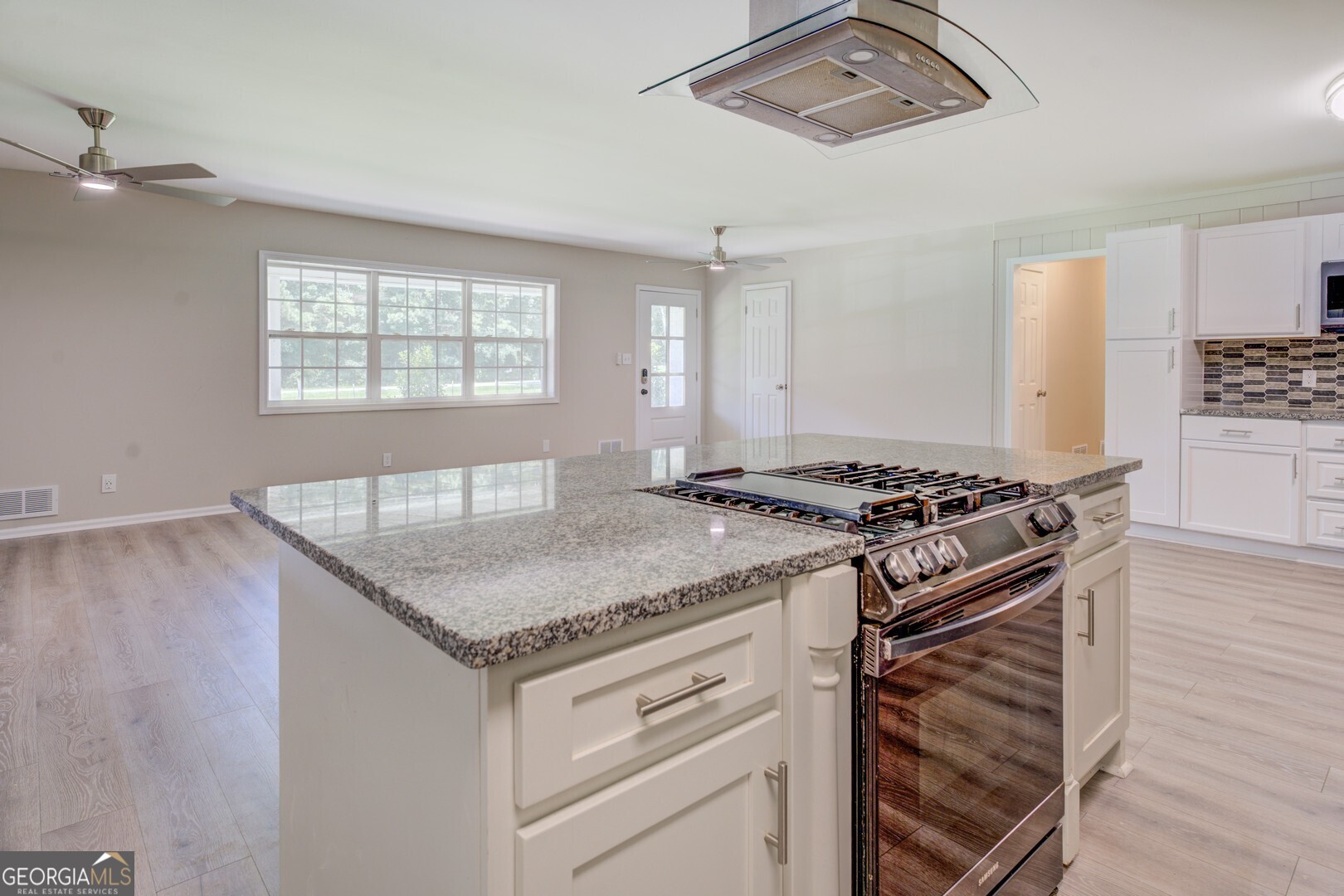 635 Jackson Lake Road Mansfield, GA 30055 - Photo 20 of 68 a kitchen with stainless steel appliances granite countertop a stove and a sink