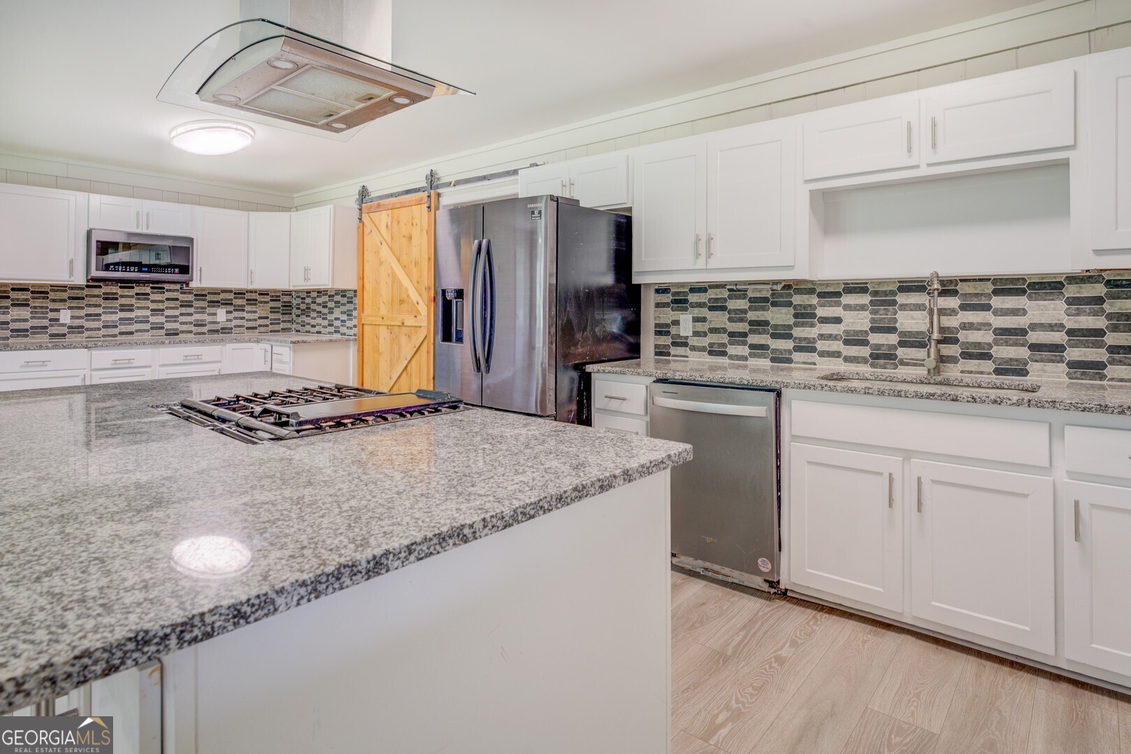 635 Jackson Lake Road Mansfield, GA 30055 - Photo 21 of 68 a kitchen with stainless steel appliances granite countertop a sink and cabinets
