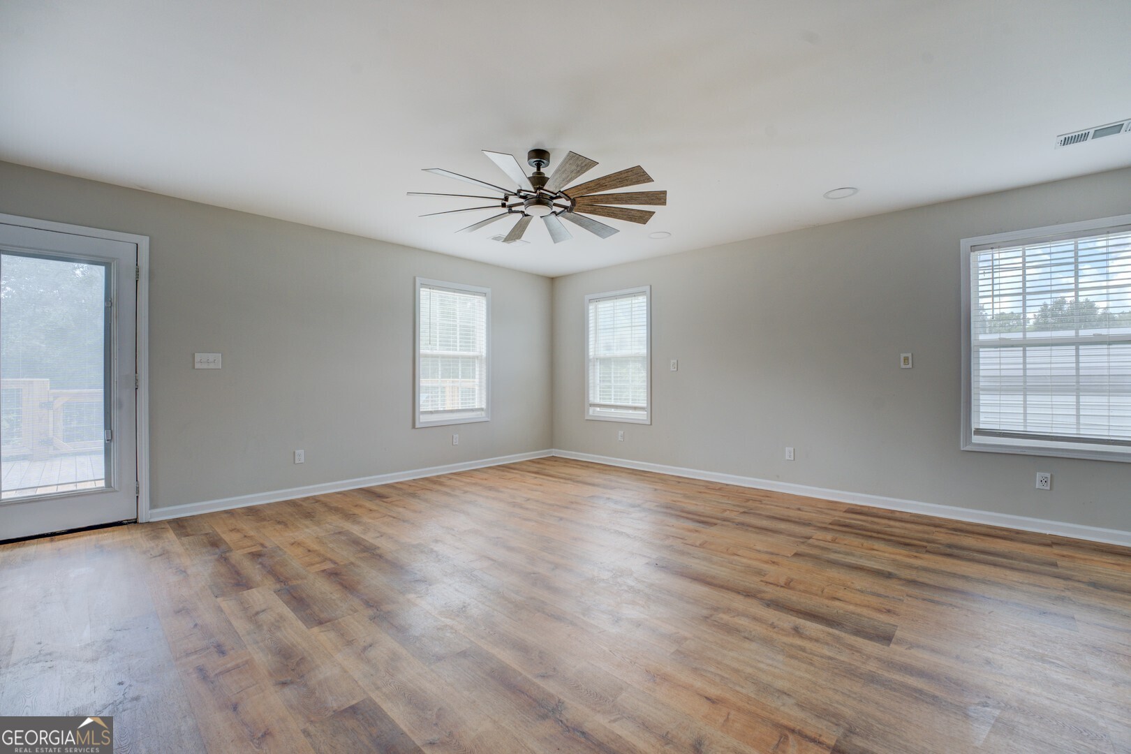 635 Jackson Lake Road Mansfield, GA 30055 - Photo 25 of 68 wooden floor in an empty room with a window
