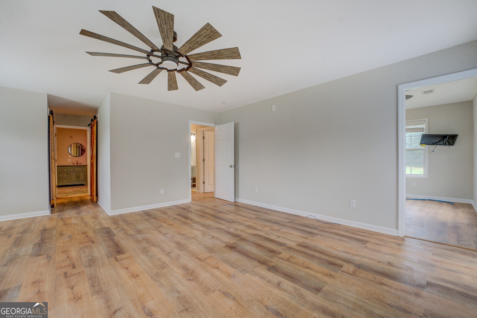 635 Jackson Lake Road Mansfield, GA 30055 - Photo 27 of 68 a view of an empty room with window and wooden floor