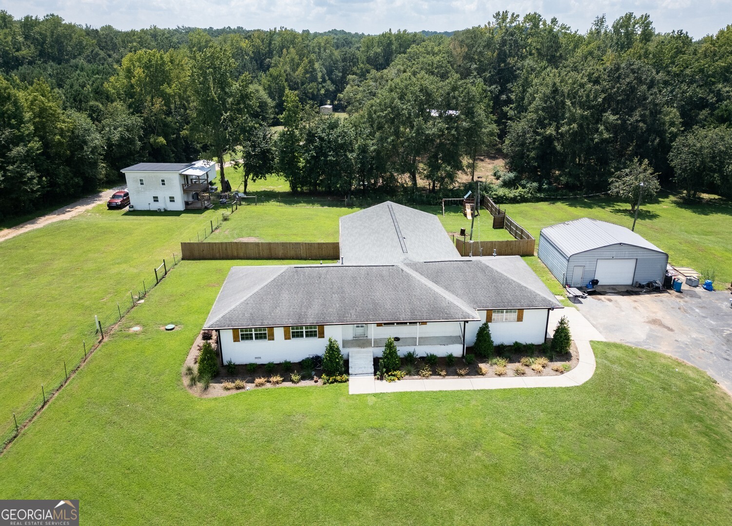 635 Jackson Lake Road Mansfield, GA 30055 - Photo 3 of 68 a aerial view of a house with swimming pool lawn chairs and a yard