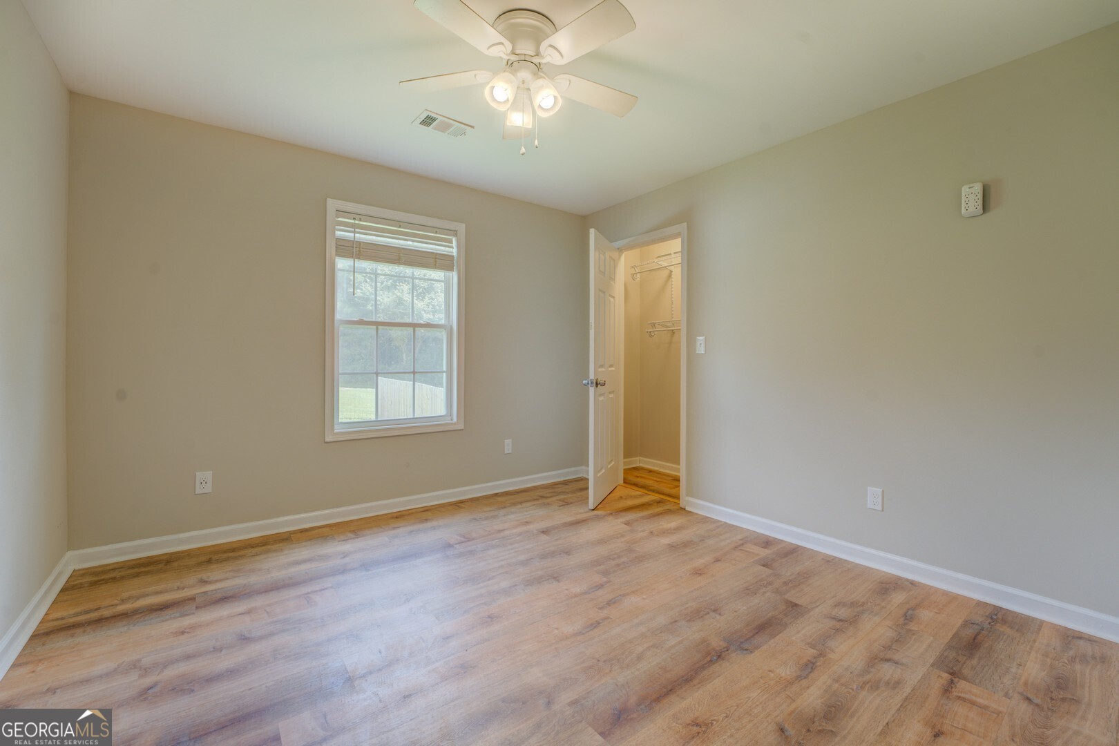 635 Jackson Lake Road Mansfield, GA 30055 - Photo 36 of 68 a view of an empty room with window and chandelier fan